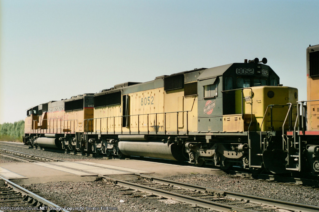 Chicago & Northwestern SD60 #8052 (with SD60M #6102) in the consist of a westbound passing the depot 